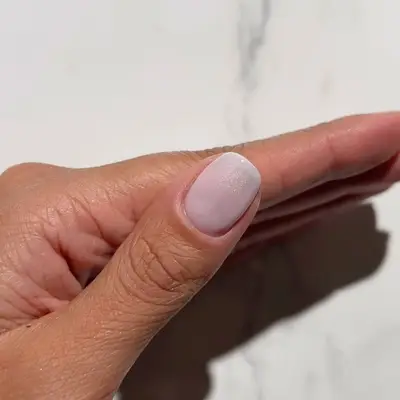 Close-up of sheer frosted winter white manicure