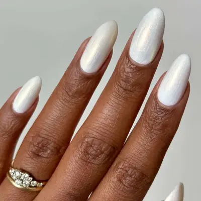 Close-up of shimmery white manicure