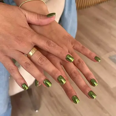 Green chrome manicure on short nails
