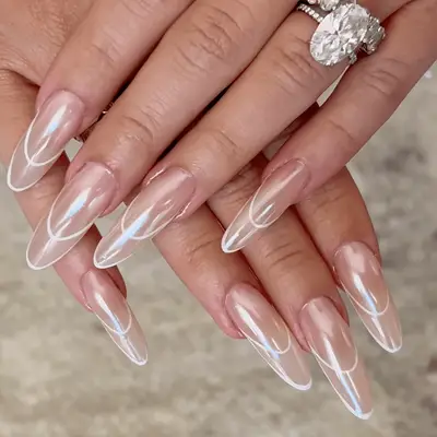 Close up of a manicure with an oat milk base and chrome web details