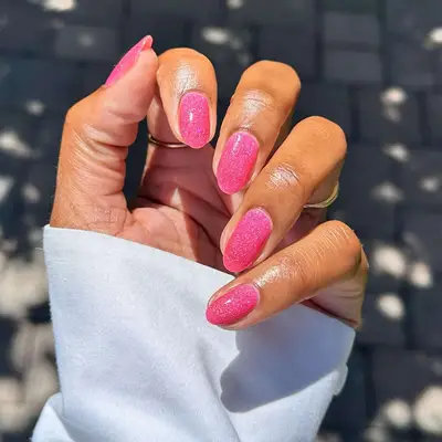 A shimmering hot pink manicure