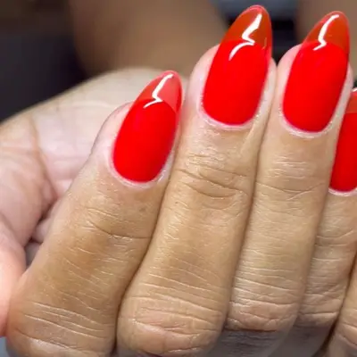 A red jelly manicure, viewed close up
