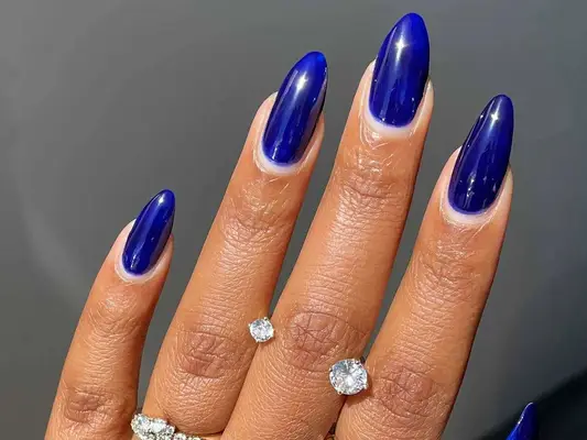 A cobalt blue manicure in almond-shaped nails