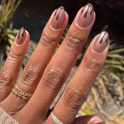 dark brown and gold dripping nails