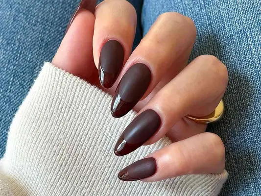 a dark brown two-tone french manicure with matte and glossy finishes