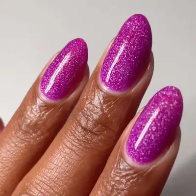 Manicure with purple berry base and sparkly finish