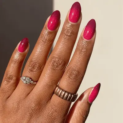 Manicure with pastel shimmer pink base and vivid strawberry ombre tips