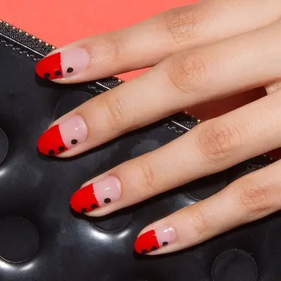 Black and red nail design with dots