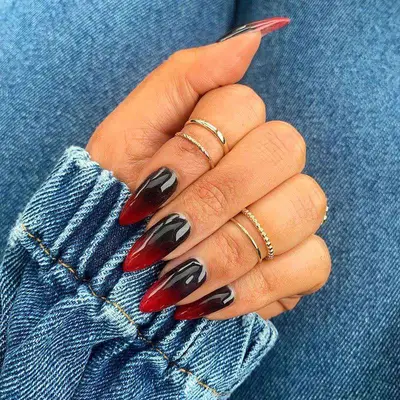 Black and red ombrÃ© nails with midi rings