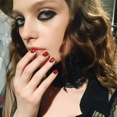 Reverse French manicure with black base and red allover color