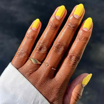 A neon yellow mani with negative space details