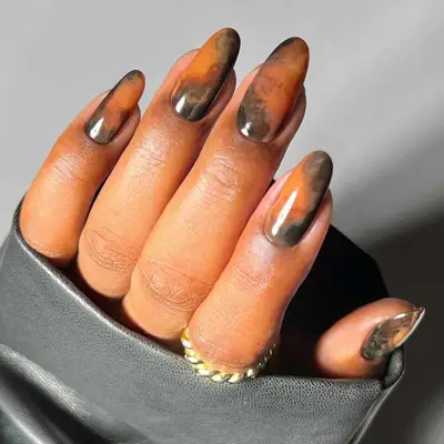 A smoky marble mani in shades of orange and grey