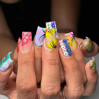 A manicure with various abstract designs and multiple textures