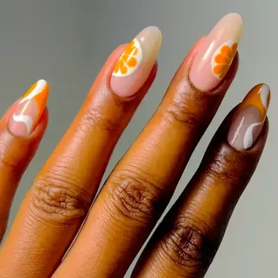 a manicure with citrus slices and french tips and swirls