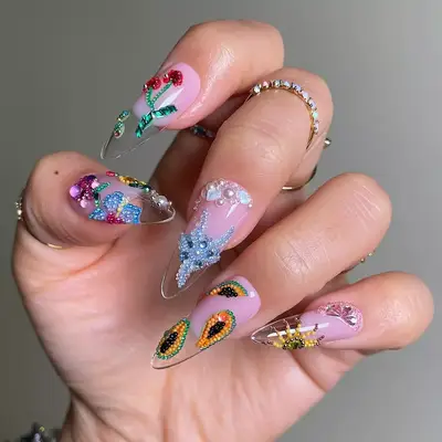 a manicure topped with intricate beaded fruit designs