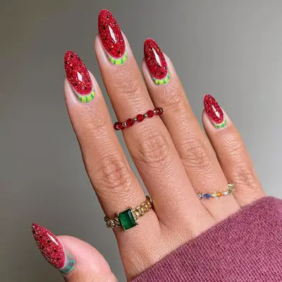 a glittery watermelon manicure