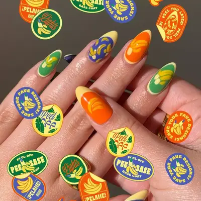 a manicure in blue, green, orange, and yellow with bananas