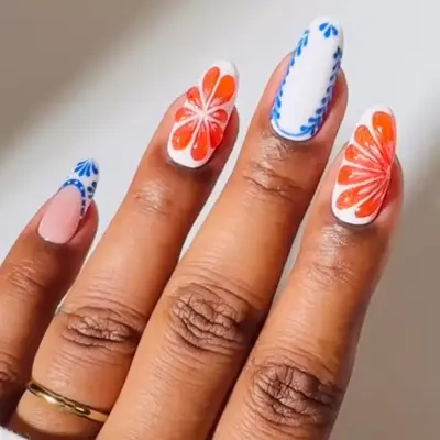 a manicure with orange slice and porcelain designs