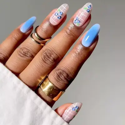 a blueberry manicure with grid designs 