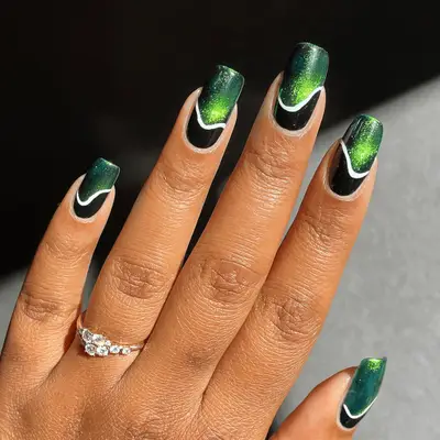 Long square nails with dark green velvet polish and white curvy lines