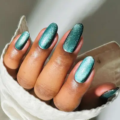 a shimmery teal velvet glass manicure