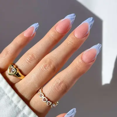 a light blue manicure with builder gel swirl accents