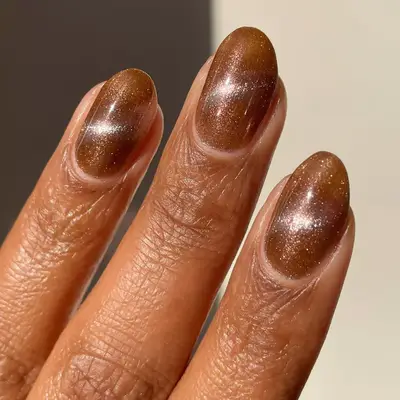brown magnetic polish with silver shimmer on short rounded nails