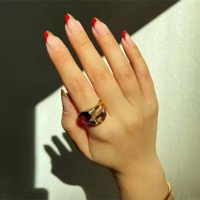 two-tone red and gold french tip nails