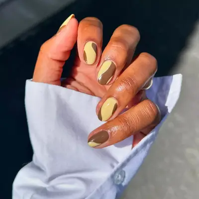 milky chocolate and yellow swirl nails