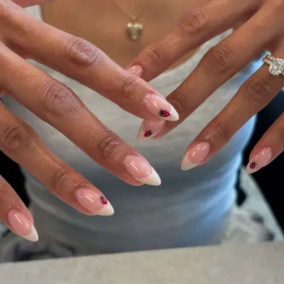 French manicure with strawberry accent on short stiletto.