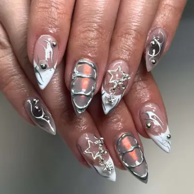 3D metallic manicure on short, stiletto-shaped nails.