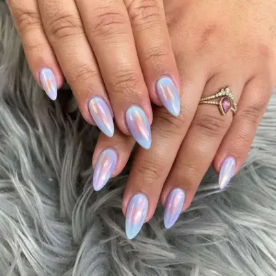 Aurora chrome manicure on short stiletto-shaped nails.