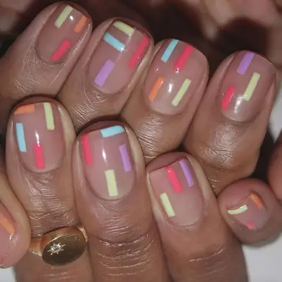 Clear nails with a confetti design on square tips