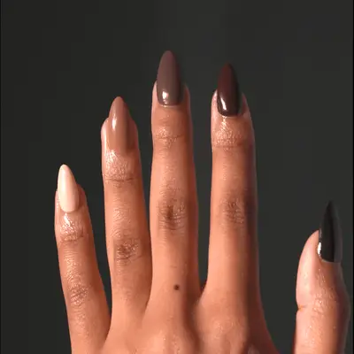 Mocha, caramel, and white chocolate nails with negative-space half moons at the base