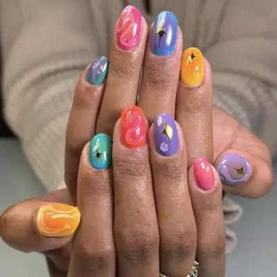 Hand with glossy pink manicure, white shirt sleeve visible