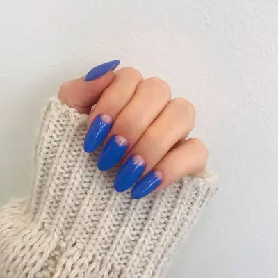 True blue manicure with negative space classic half-moon nail design