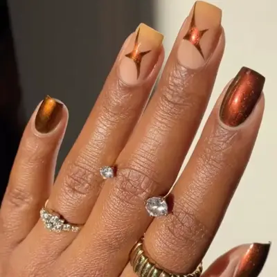 amber chrome nails with stars