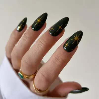forest green nails with gold stars