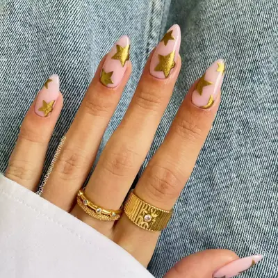 light pink nails with gold stars