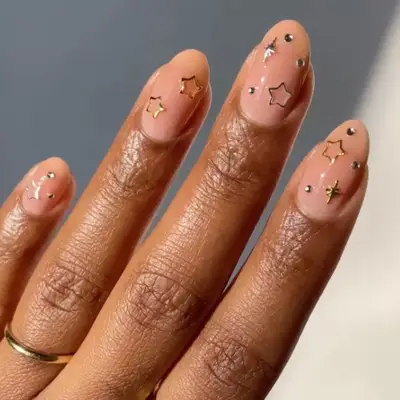 nude nails with silver and gold charm stars