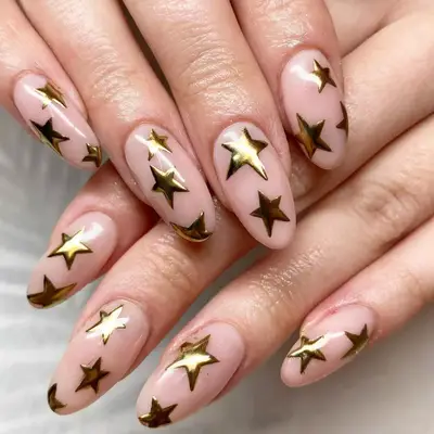 light pink nails with gold stars