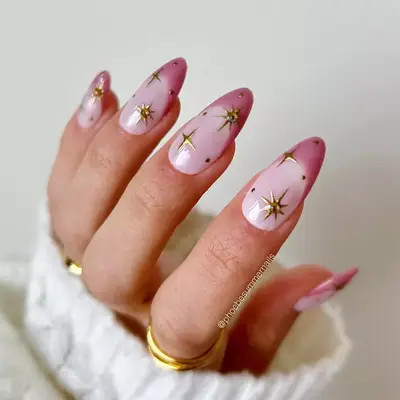 pink french tip nails with gold stars