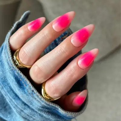 pink aura design on long almond nails