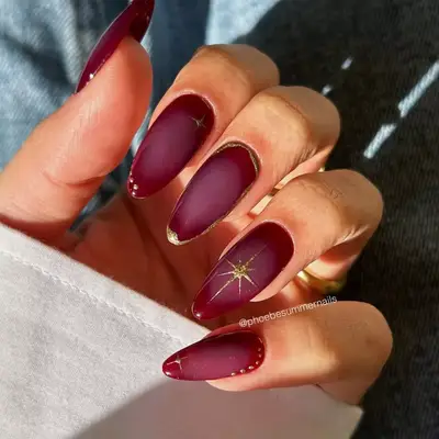 Burgundy aura nails with gold detailing