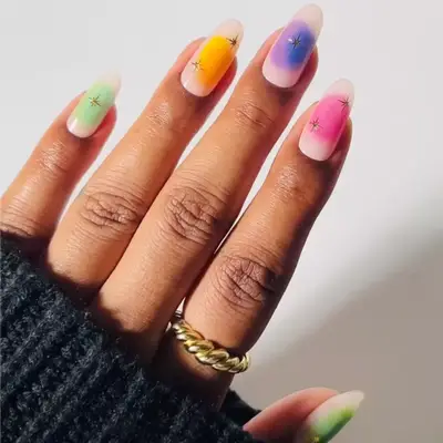 colorful aura nails with gold star designs