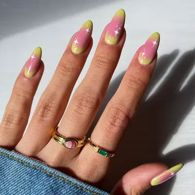 Pink and yellow aura nails with white star detail