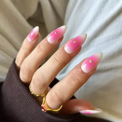 Long nails with pink and white aura manicure and gold heart detail