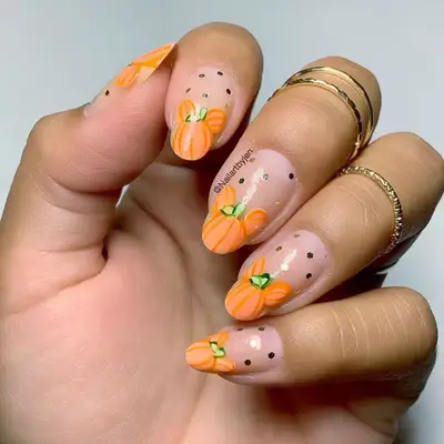 Negative space manicure with Mickey Mouse-shaped pumpkin tips