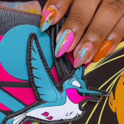 Pocahontas-inspired blue, pink, orange, and gold manicure