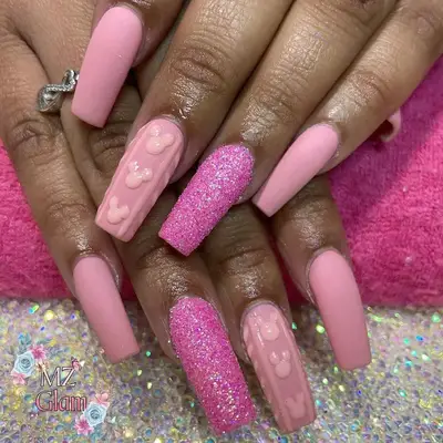 Pink nail design with glitter accent and Mickey Mouse detail